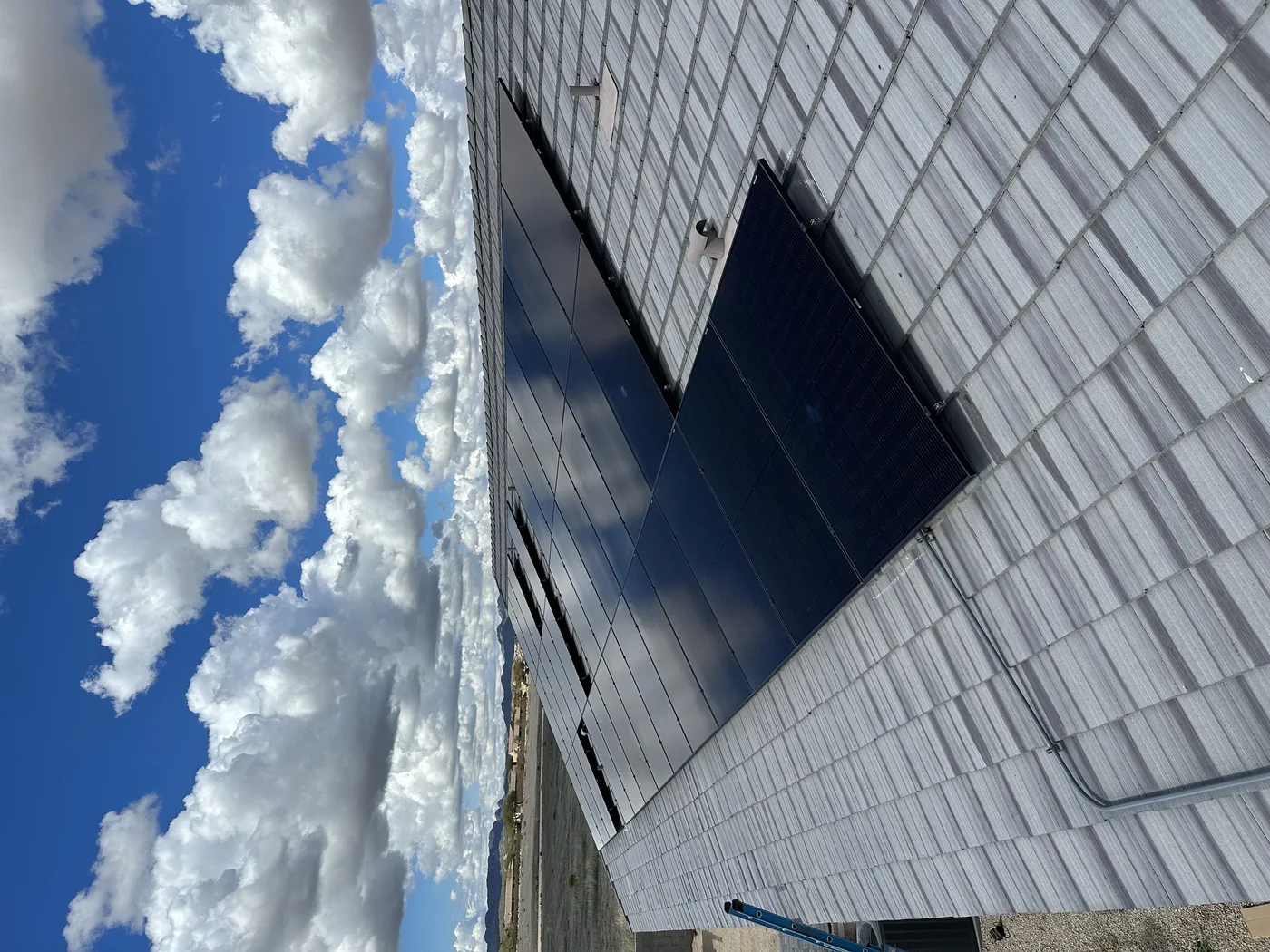 Solar panel installation viewed across a shingle roof
