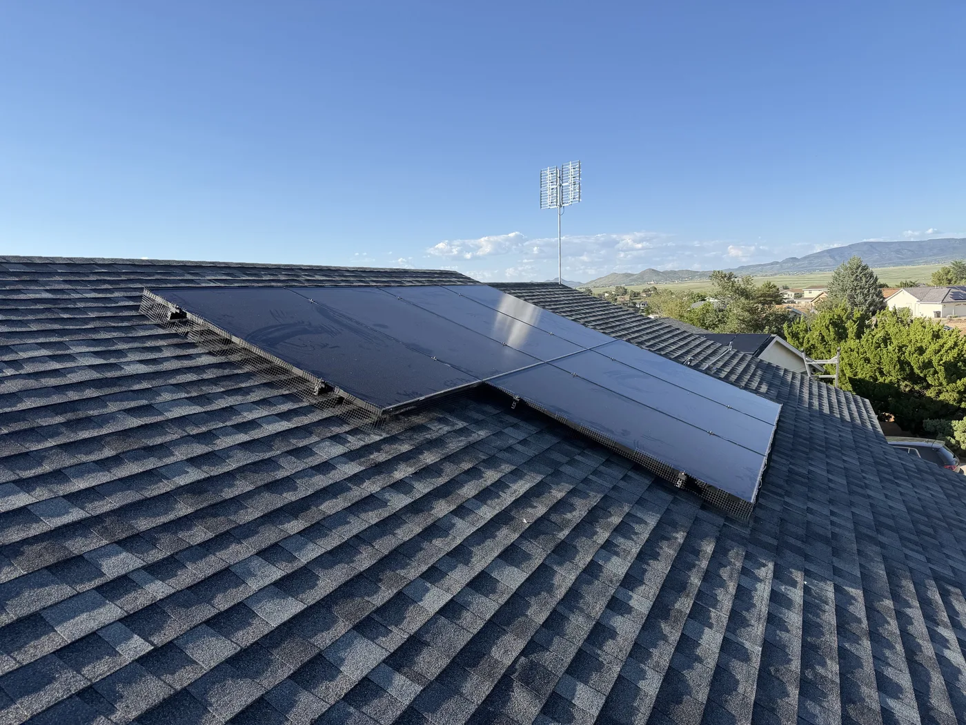 Low-profile solar array installed on a shingle roof